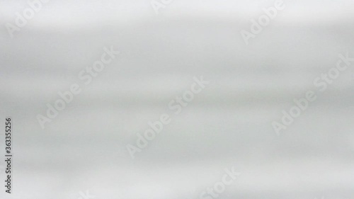A blue medicine protective mask in hands in gloves approaching to camera. Close up view. Consept of antivirus protection