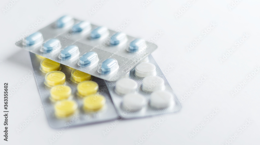 Medicine capsule dosage form antibiotic and painkiller drug in blister packaging on white background for medical, pharmaceutical and health care concept. Medicine capsule dosage form antibiotic and painkiller drug in blister packaging on white background for medical, pharmaceutical and health care concept.