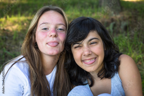Two teenage girls fool around in front of the camera.