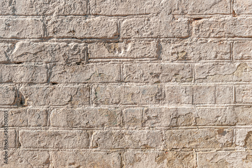abstract background of an old brick wall painted beige close up