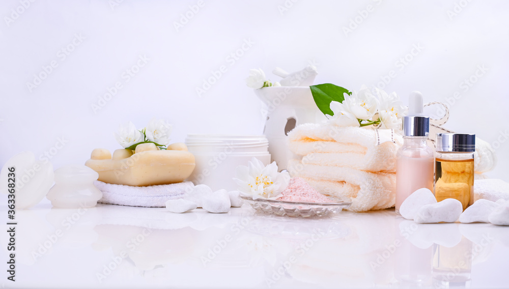 Various spa and beauty threatment products isolated on white background. Skin cream, tonicum bottle, dry flowers, leaves, rose and Himalayan salt. Organic cosmetics, spa concept. Empty. Copy space.