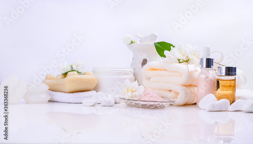 Various spa and beauty threatment products isolated on white background. Skin cream, tonicum bottle, dry flowers, leaves, rose and Himalayan salt. Organic cosmetics, spa concept. Empty. Copy space.