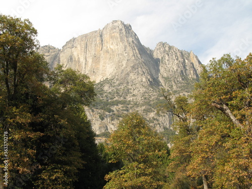 Granite mountain surrounded by trees in autumn, Yosemite National Park, California, USA