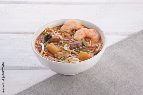 Oriental Asian soup with seafood and noodles photo