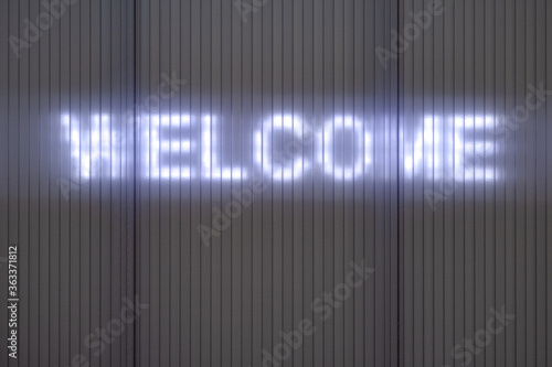 WELCOME. Writing on a Wall with illuminated lettering.