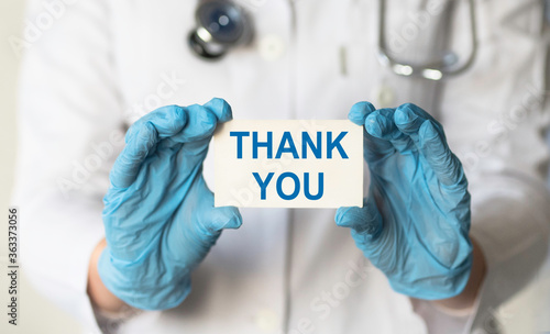 Doctor holding card with text Thank you.