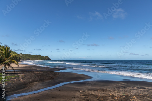 Fototapeta Naklejka Na Ścianę i Meble -  Black sand beach and breaking waves in Lorrain, Martinique, France