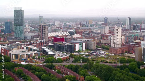 Slow drifting aerial drone shot of the city of Manchester skyline and Beetham tower from the air on a grey cloudy day photo