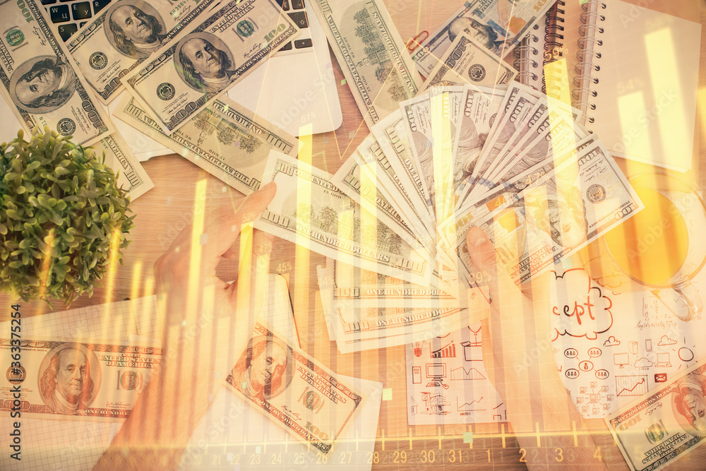 Naklejka premium Multi exposure of financial graph drawing hologram and USA dollars bills and man hands. Analysis concept.