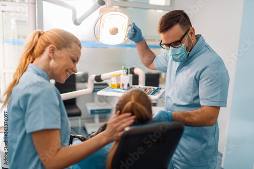 Dentist and patient in dentist office.