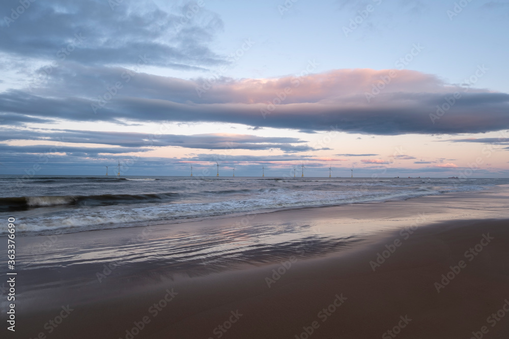 Wind Turbines in a beautiful ocean with stunning sky background