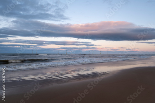Wind Turbines in a beautiful ocean with stunning sky background