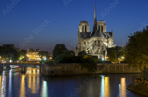 Notre Dame cathedral and seine river at dusk in Paris, France. © kemaltaner
