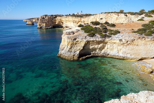 popular Marinha Beach beach with typical rock formations such as natural bridges and arches in the Algarve