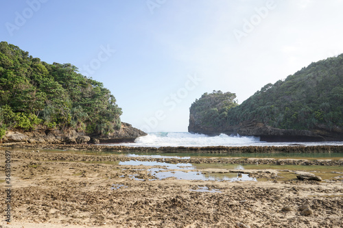 Beautiful sea wave foam at Batu Bengkung Beach. Exotic paradise in Malang, East Java, Indonesia. Scenic ocean wave view of beach. photo