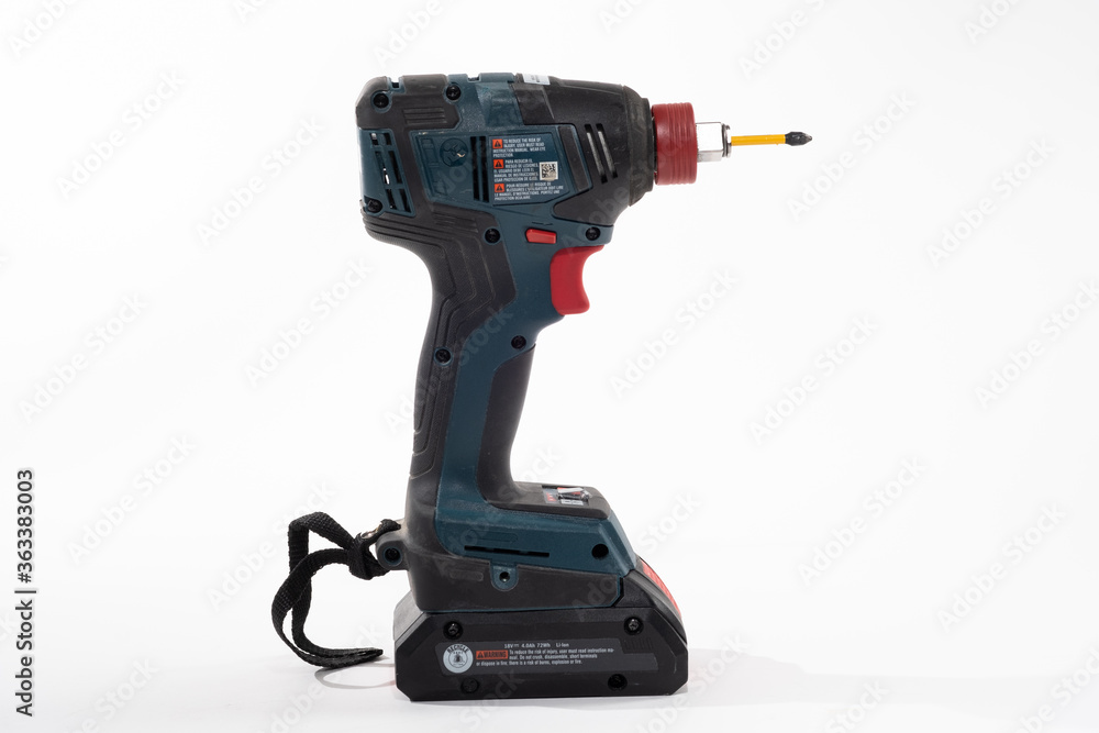 Impact Driver drill isolated on a white background with room for copy on the left