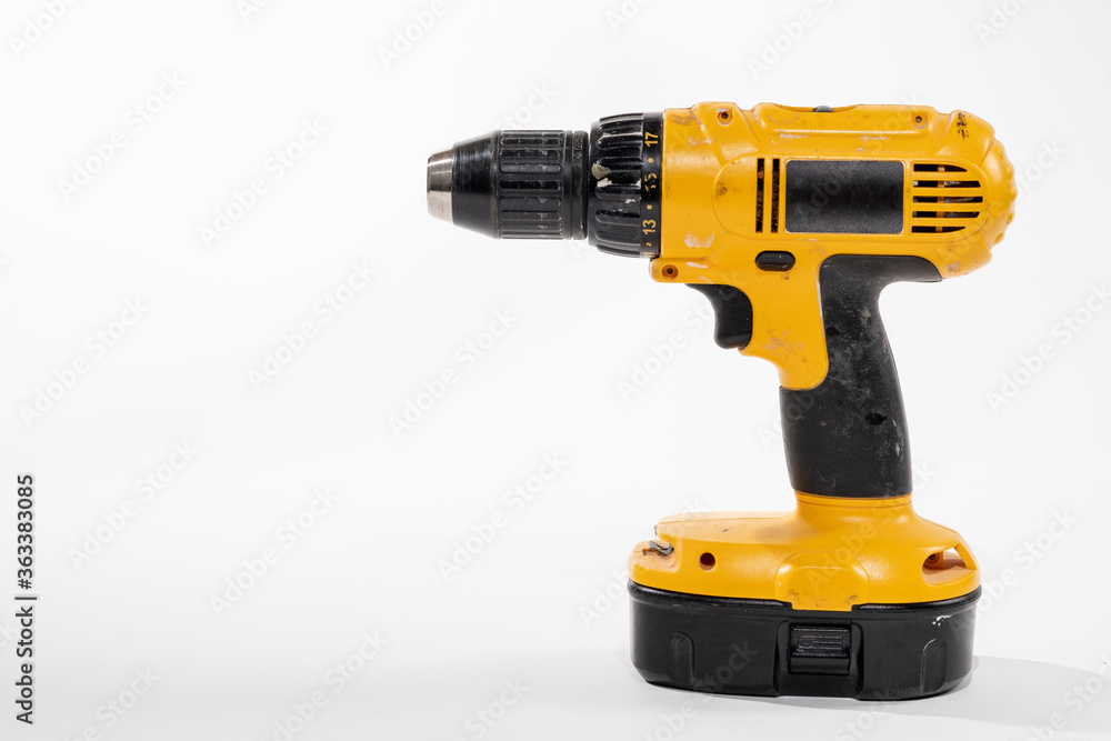 Cordless drill isolared on a white background with room for copy on the left