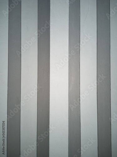 Grey and dark grey strips on the wall for background texture or wallpaper