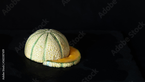 
Melon in the shape of a cap on a black background