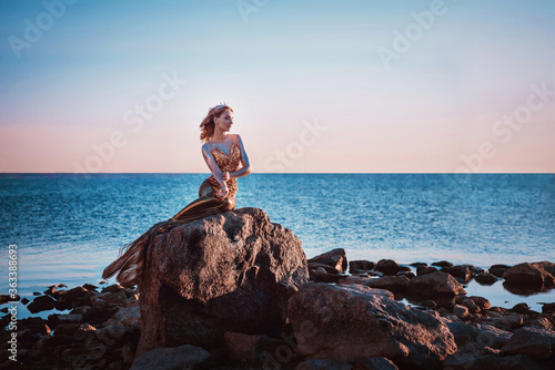 Tableau sur toile Sadness mermaid, nixie, water nymph sitting on stone