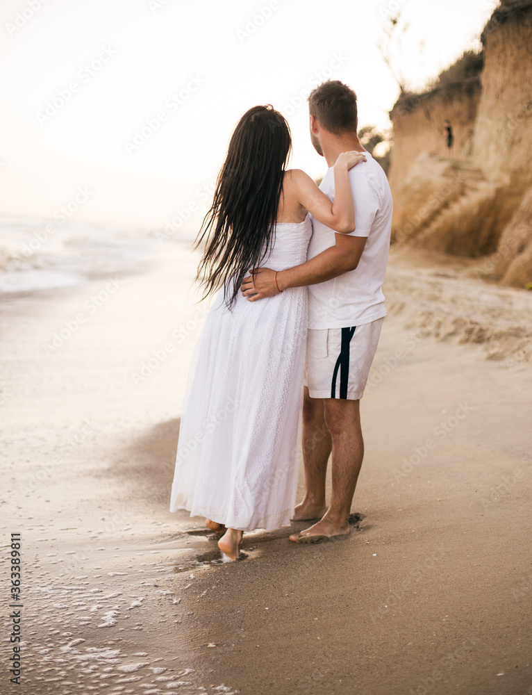 Beach couple walking on romantic travel honeymoon vacation summer holidays romance. Young happy lovers. Beach couple walking on romantic travel honeymoon vacation summer holidays romance. Young happy lovers.