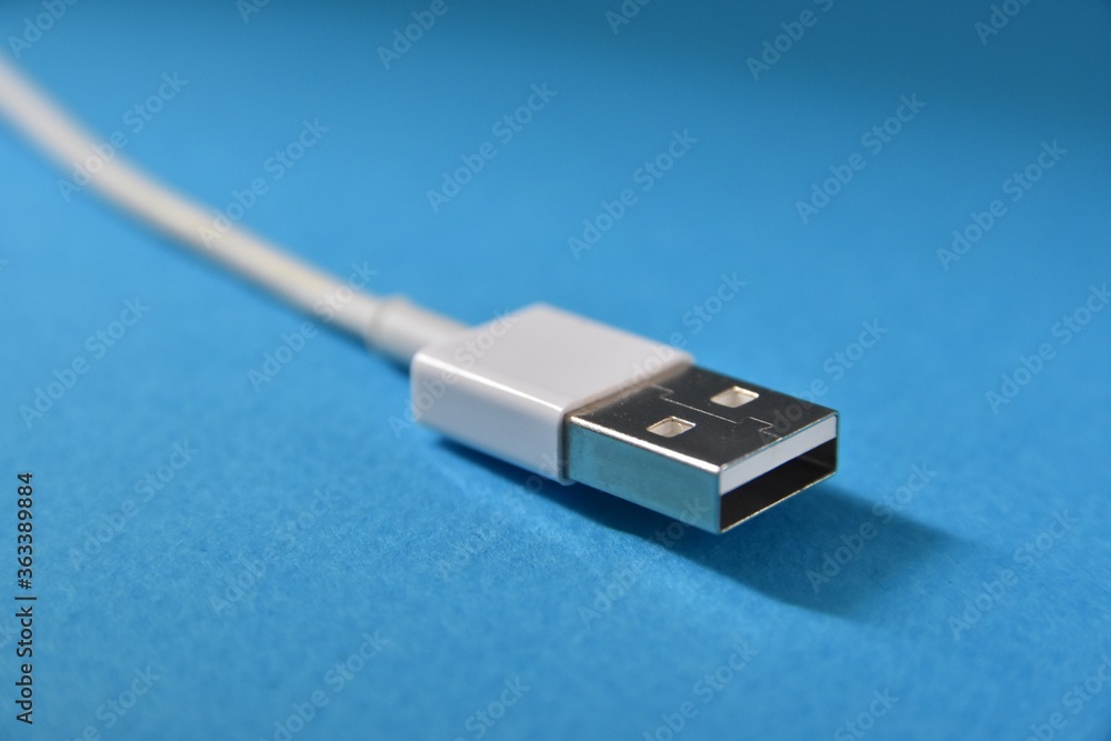 USB cable icon for web on blue background. Connection for computer peripherals or charger for smartphones USB cable icon for web on blue background. Connection for computer peripherals or charger for smartphones