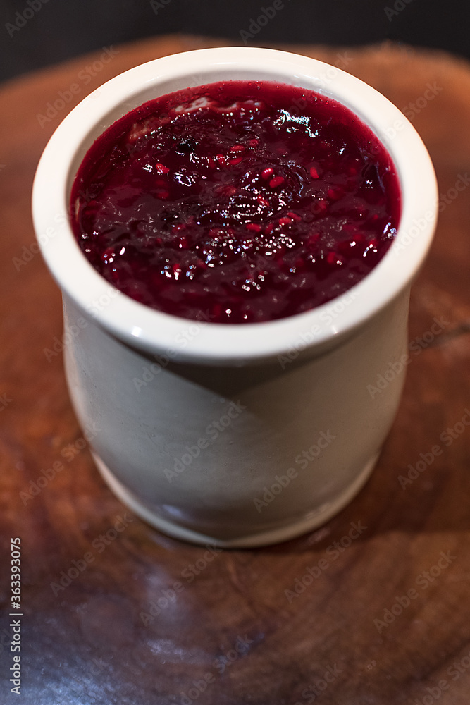 Homemade cheese cake with red fruit jam made in a ceramic jar Homemade cheese cake with red fruit jam made in a ceramic jar