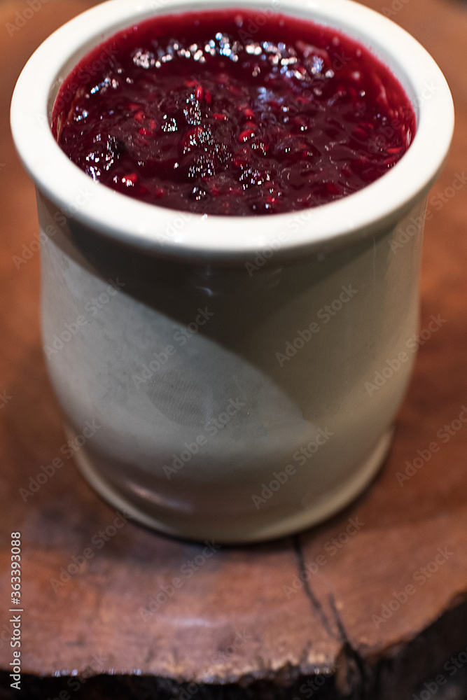 Homemade cheese cake with red fruit jam made in a ceramic jar Homemade cheese cake with red fruit jam made in a ceramic jar