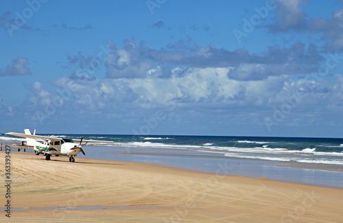 Beautiful image of Fraser Island along 75 miles beach showing blue sky, sand, water and waves