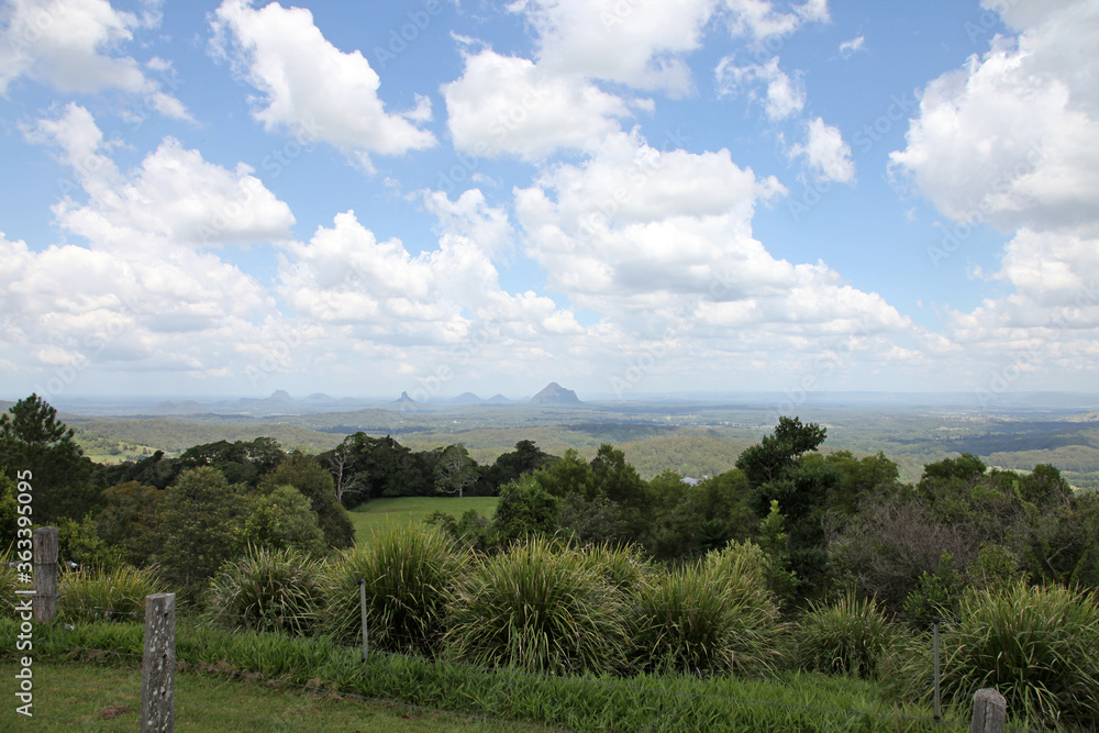 Glass House Mountains, Sunshine Coast, Queensland, Australia showing blue sky, mountains, paddocks, farming land and forests