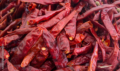 Dried red hot chili peppers in a sack of food ingredients Spread the dry chilli background.