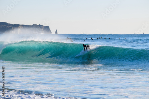 Photography Surfer on Blue Ocean Wave riding on surfing board in Asia