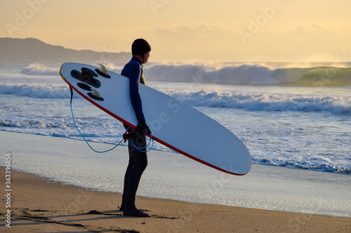 Photography Surfer on Blue Ocean Wave riding on surfing board in Asia