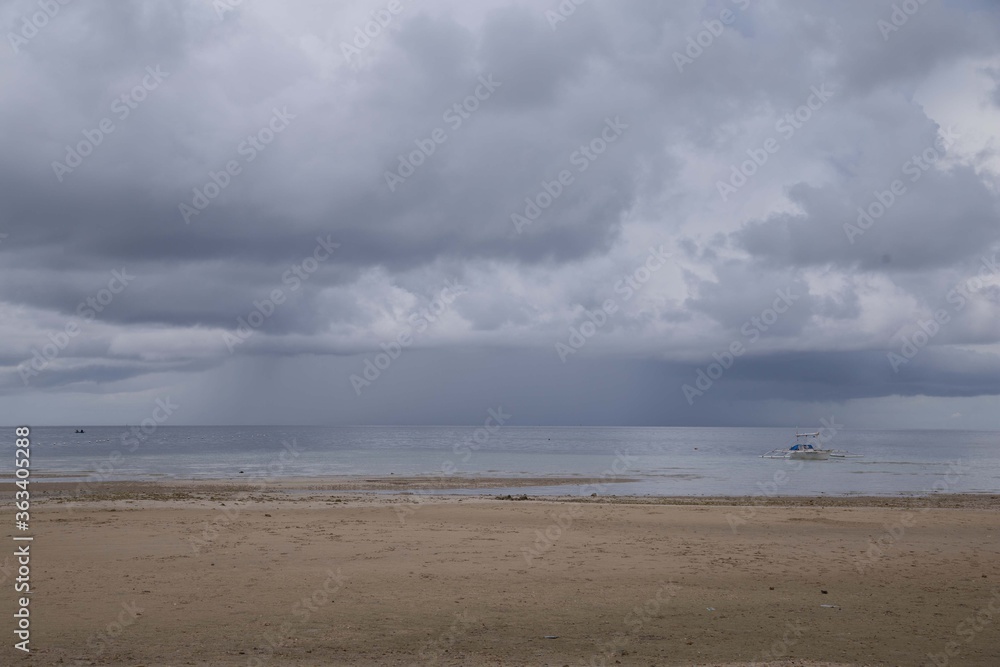 upcoming thunderstorm at the beach and shoreline with dark clouds