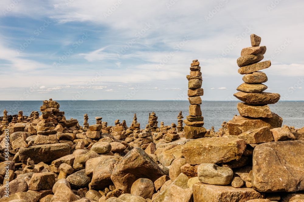 Several piles of balancing rocks at the seashore Several piles of balancing rocks at the seashore
