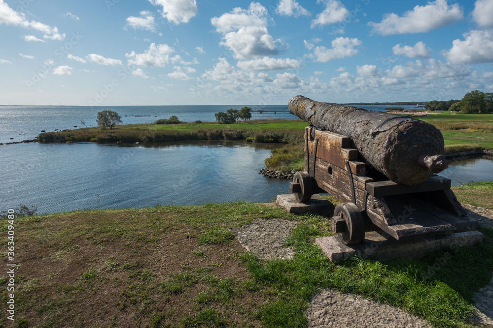 Wooden and rusty medieval cannon at a fort close to the sea Wooden and rusty medieval cannon at a fort close to the sea