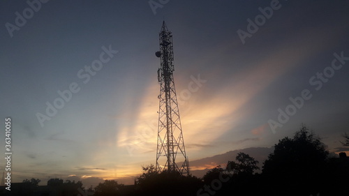 Telecommunication tower with colourful sky background 