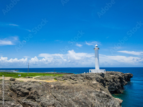 夏のさわやかな青空と沖縄の観光スポットの残波岬灯台と海と崖 04