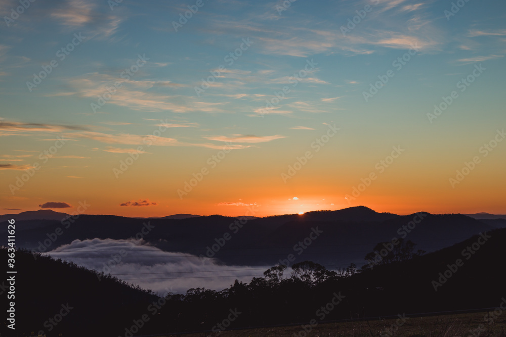 sunrise sky with beautiful clouds rolling over the hills of Tasmania