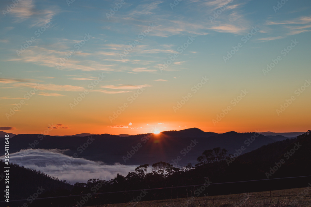 sunrise sky with beautiful clouds rolling over the hills of Tasmania