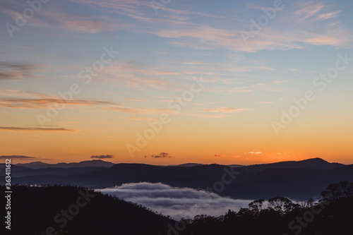 Fototapeta Naklejka Na Ścianę i Meble -  sunrise sky with beautiful clouds rolling over the hills of Tasmania