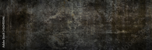 Texture of a grungy black concrete wall as background