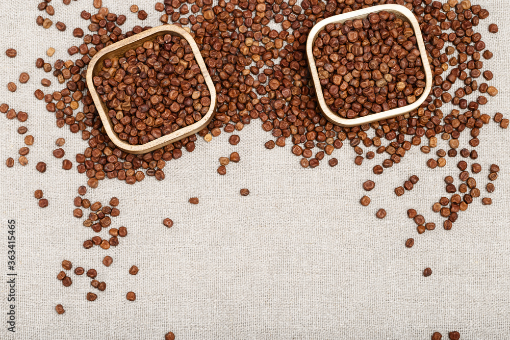 Raw gray peas in wooden bowls on light tablecloth with copy space. Organic healthy diet food. Traditional Latvian product. Legumes bean seed. Raw gray peas in wooden bowls on light tablecloth with copy space. Organic healthy diet food. Traditional Latvian product. Legumes bean seed.