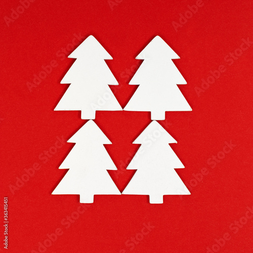 New years Christmas tree white color on red background. Christmas greeting card. Minimal style.