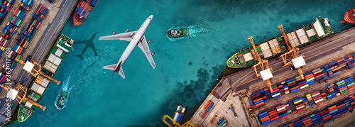 Aerial view and top view cargo plane flying above ship port in the export and import business and logistics international goods. Shipping cargo to harbor by crane