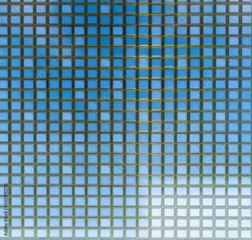 detail of a silicon wafer reflecting different colors.