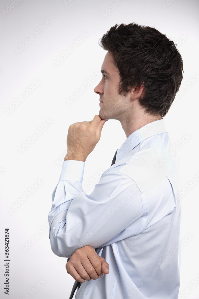 Businessman touching his chin while thinking Businessman touching his chin while thinking