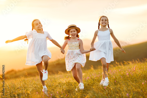 Happy children running in field.