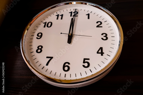 top view of round white wall clock isolated on wooden table