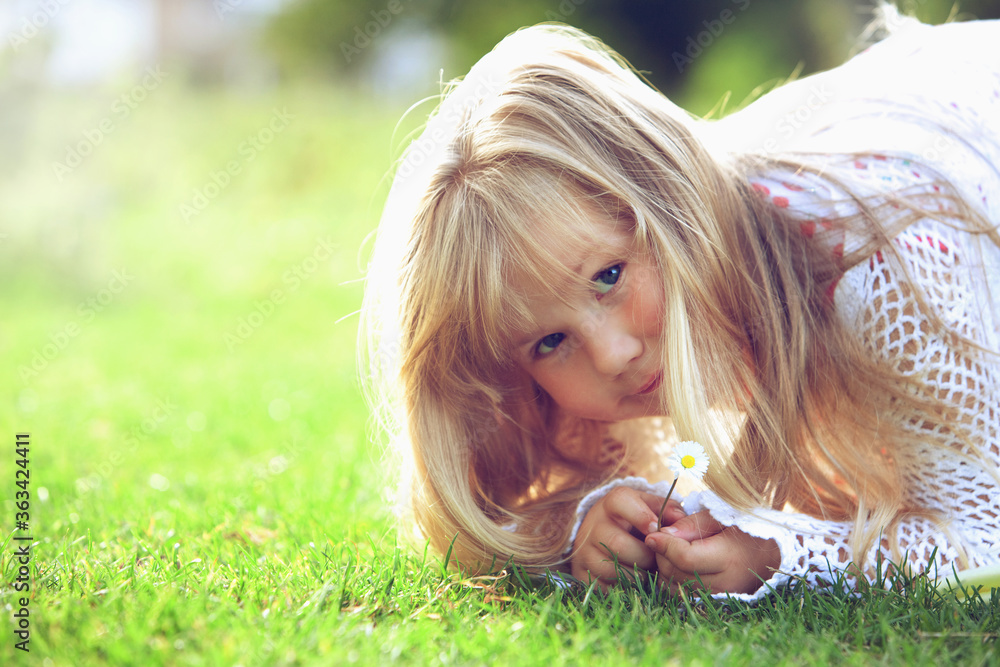 Girl holding a small daisy